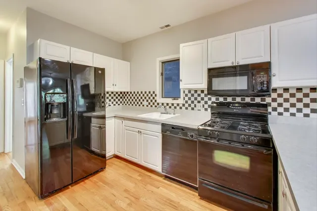 a kitchen with granite countertop cabinets and steel stainless steel appliances