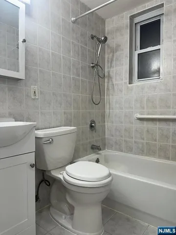 a bathroom with a toilet a sink and shower