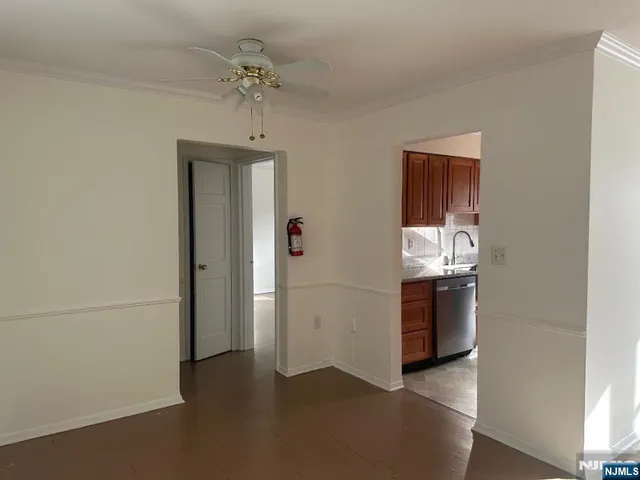 a view of a kitchen with a sink refrigerator and cabinet