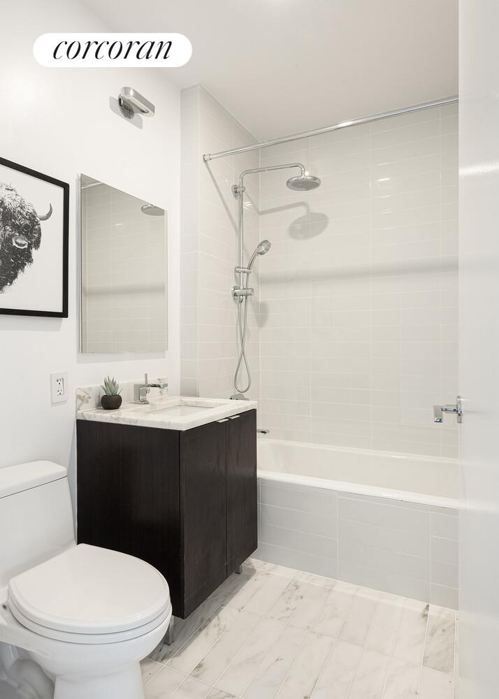 101 Warren Street, Unit 1450 Manhattan, NY 10007 - Photo 10 of 20 a bathroom with a sink a toilet and shower