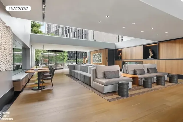 a living room with furniture kitchen view and a large window