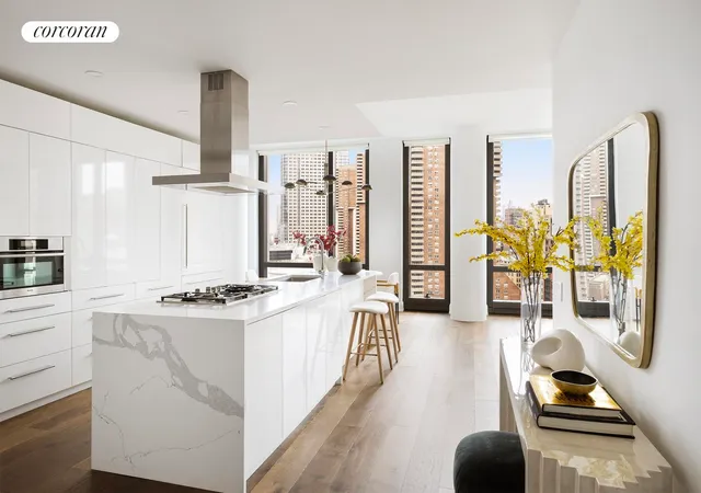 a kitchen with stainless steel appliances a stove a sink and a wooden floor