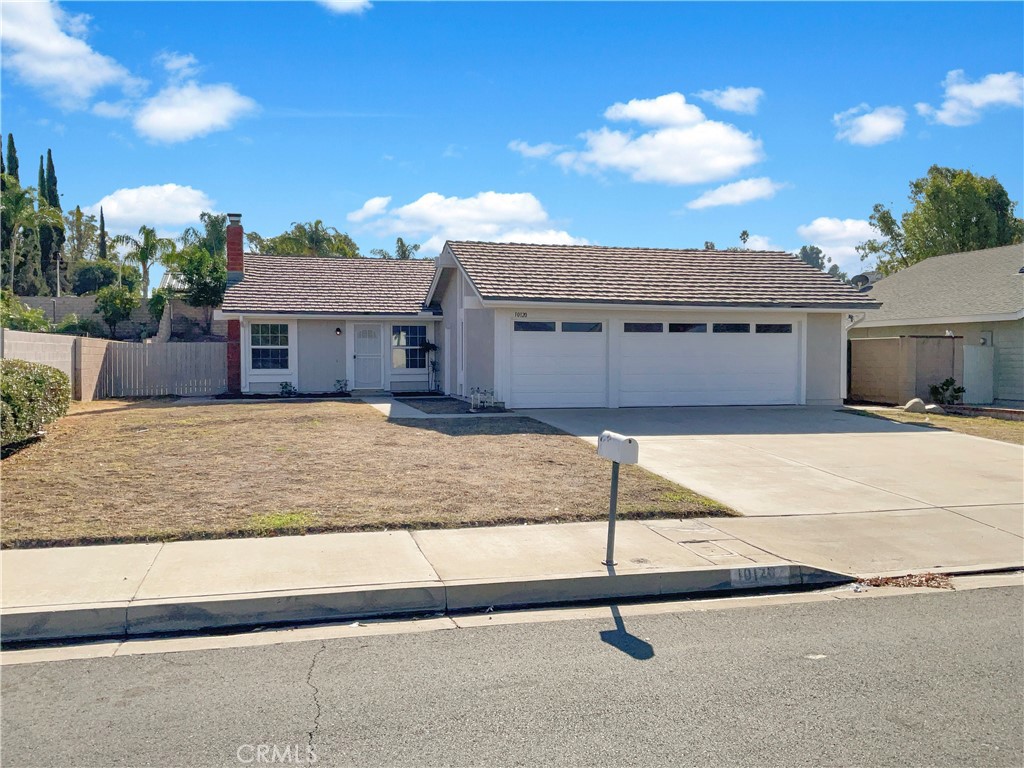 a view of a house with a wooden fence