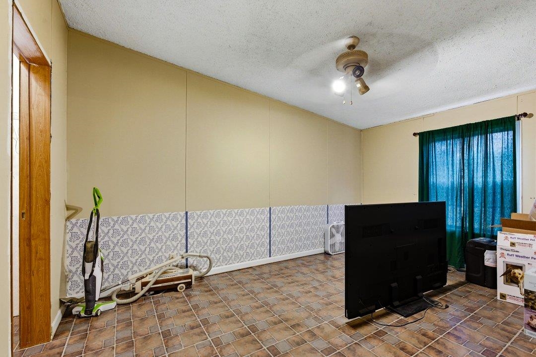 181 EV Road Loris, SC 29569 - Photo 22 of 33 Interior space featuring a textured ceiling and a ceiling fan