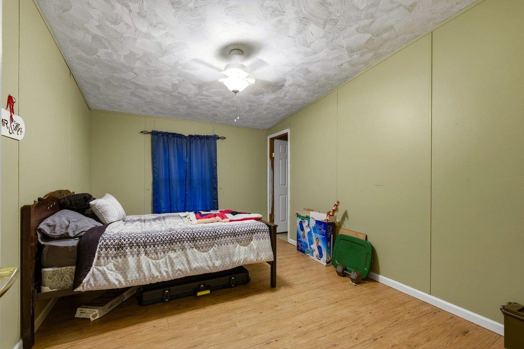 181 EV Road Loris, SC 29569 - Photo 23 of 33 Bedroom with wood finished floors and a textured ceiling