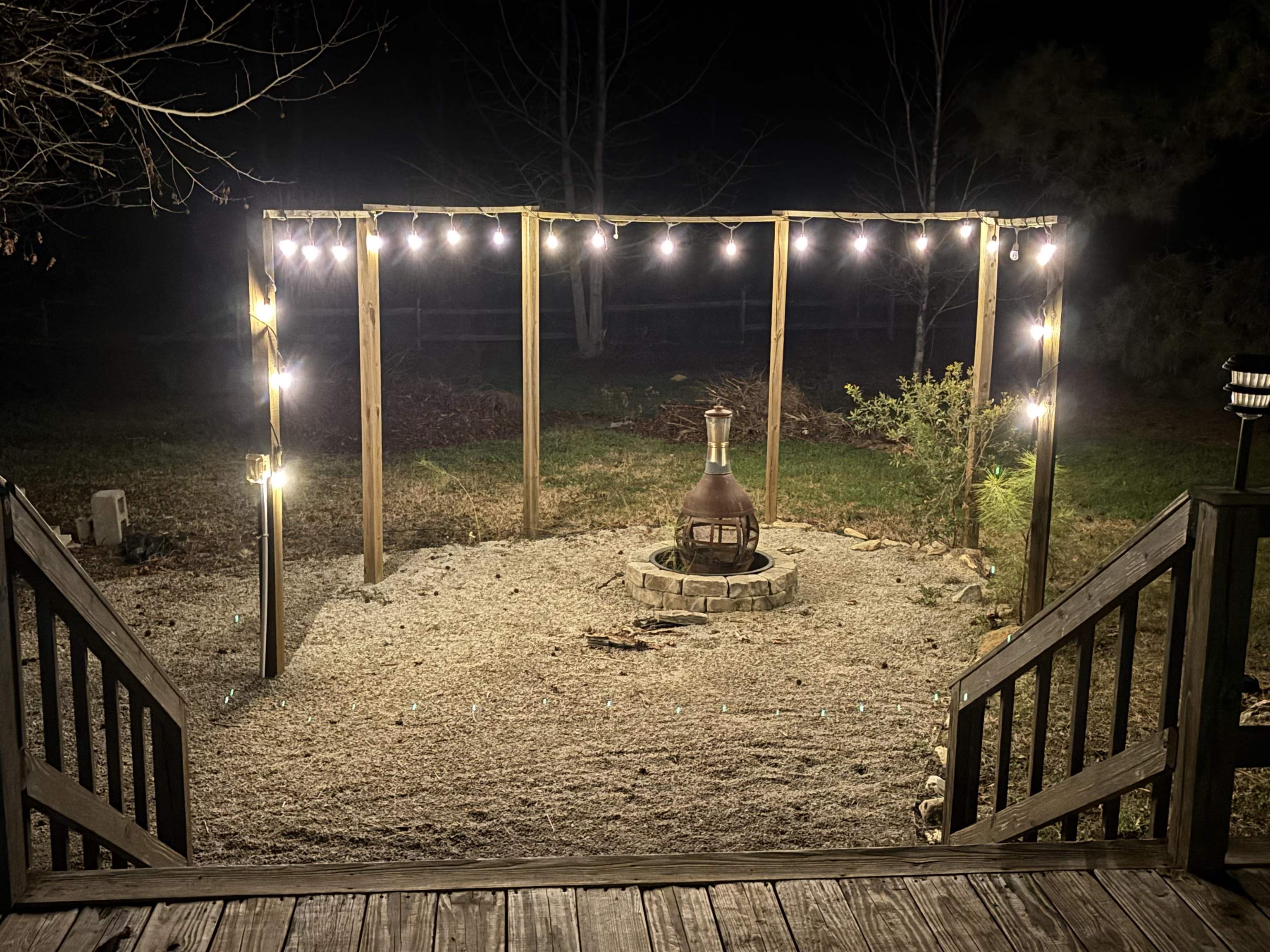 181 EV Road Loris, SC 29569 - Photo 33 of 33 Yard at twilight featuring an outdoor fire pit and a wooden deck