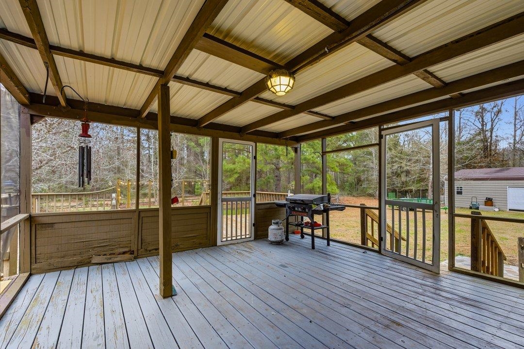 181 EV Road Loris, SC 29569 - Photo 4 of 33 Sunroom / solarium with a wooden deck and beamed ceiling