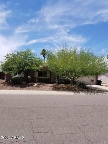 a front view of a house with a yard and a garage