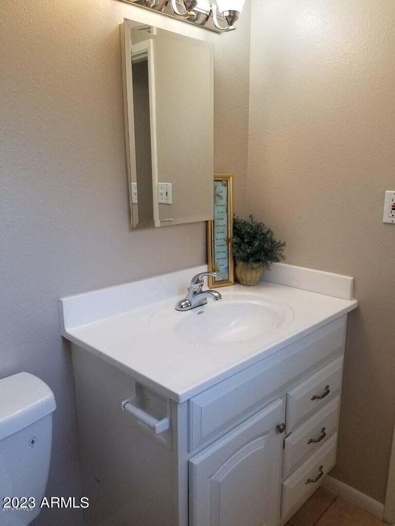 14420 North 39th Way Phoenix, AZ 85032 - Photo 17 of 24 a bathroom with a sink a toilet and mirror