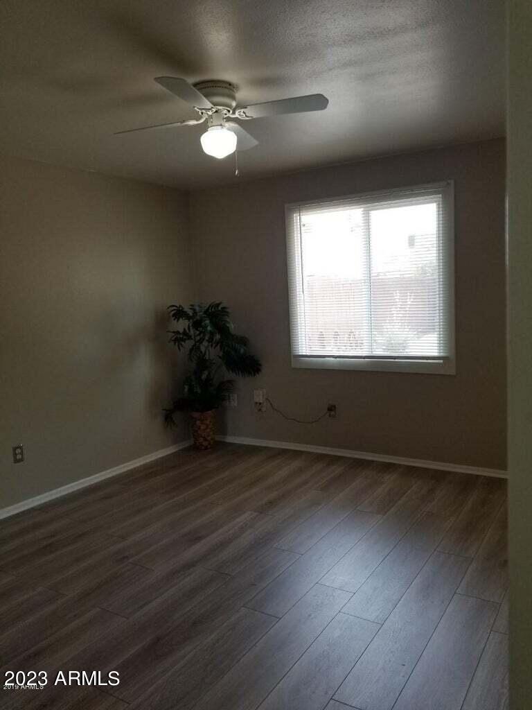 14420 North 39th Way Phoenix, AZ 85032 - Photo 20 of 24 an empty room with wooden floor and windows