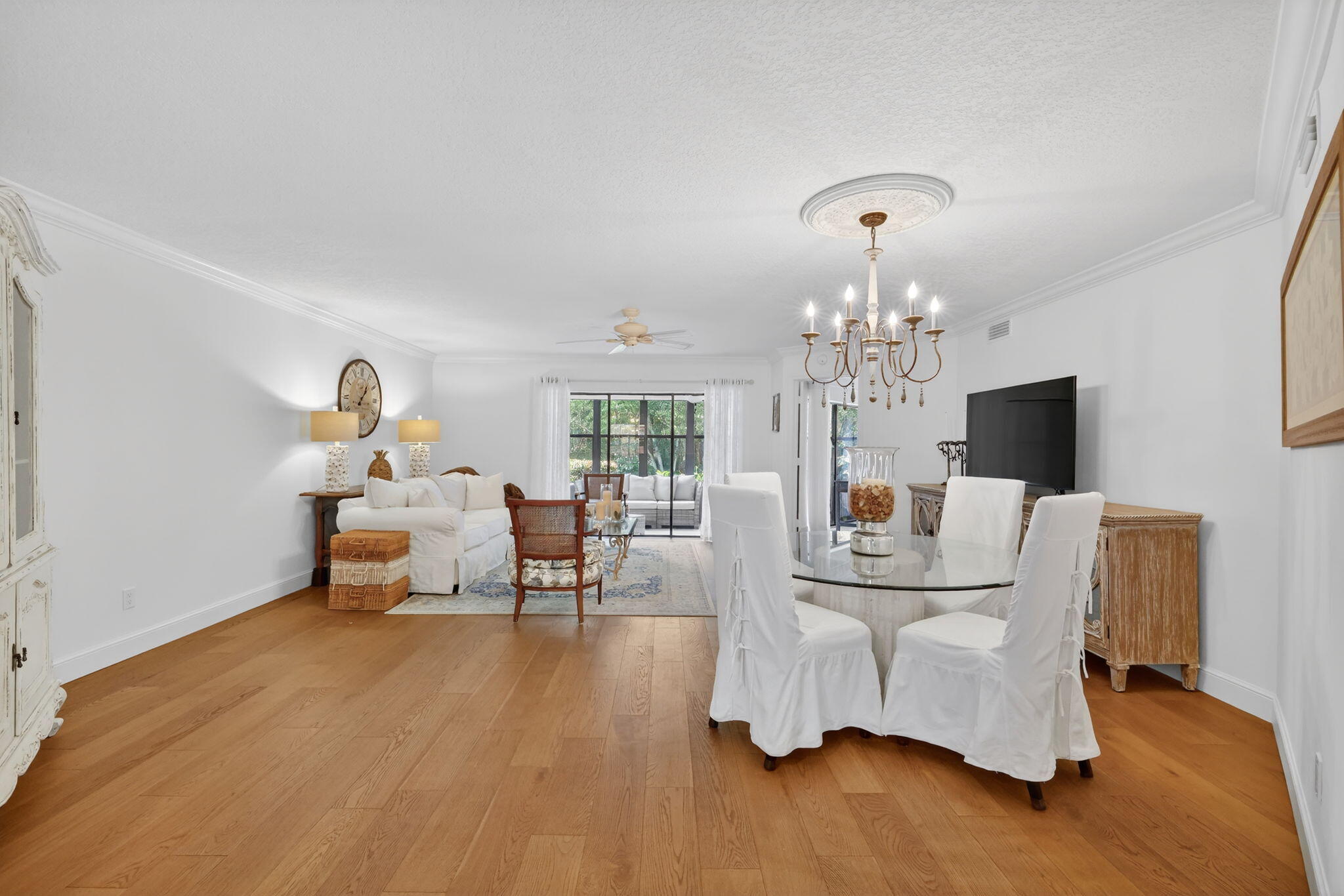 3401 Southeast Martinique Trace, Unit 102 Stuart, FL 34997 - Photo 14 of 56 a living room with furniture and a chandelier