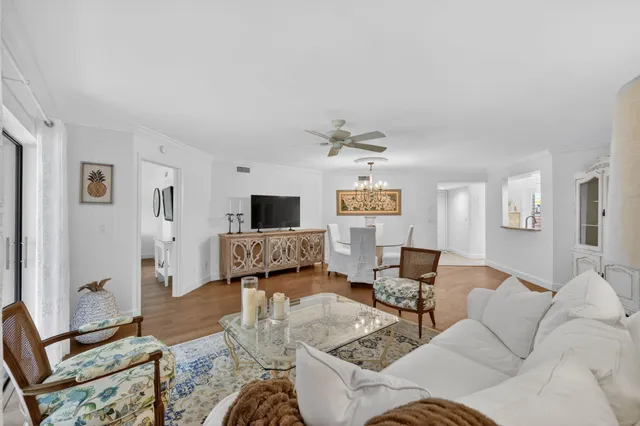 a bedroom with a bed a couch and a flat tv screen on the table
