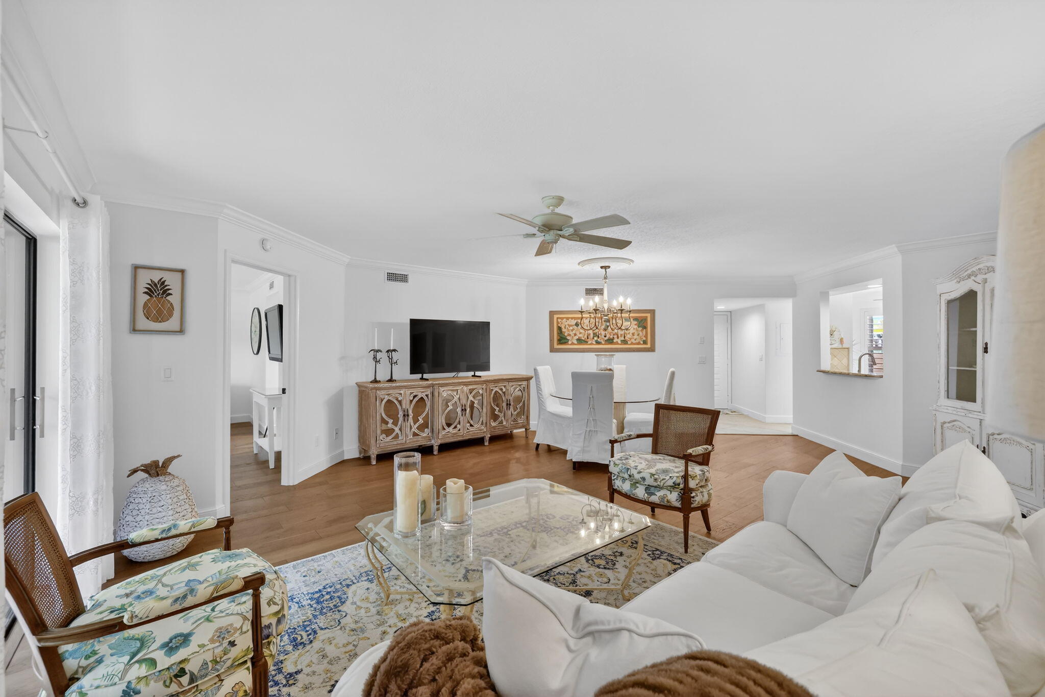 3401 Southeast Martinique Trace, Unit 102 Stuart, FL 34997 - Photo 17 of 56 a living room with furniture and a flat screen tv