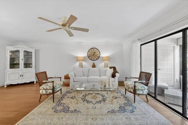 a bedroom with a bed a mirror and a large window