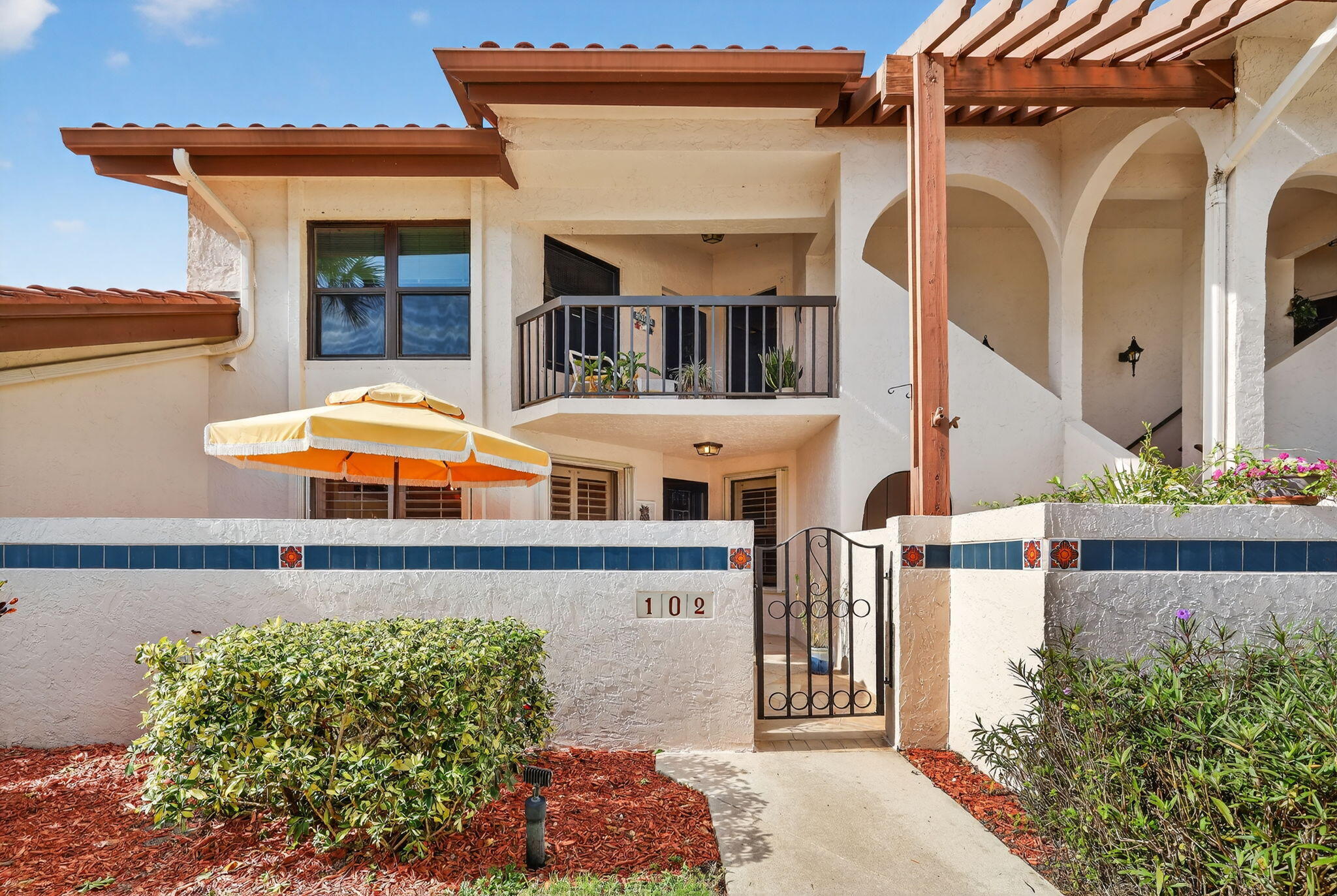3401 Southeast Martinique Trace, Unit 102 Stuart, FL 34997 - Photo 2 of 56 front view of a house with a street