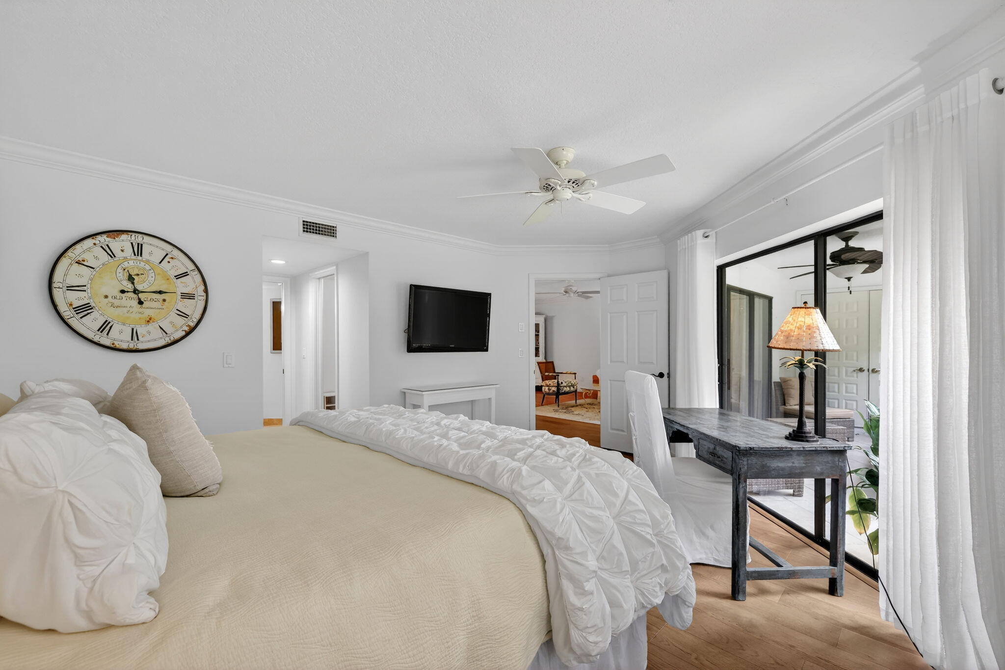 3401 Southeast Martinique Trace, Unit 102 Stuart, FL 34997 - Photo 21 of 56 a bedroom with a bed a mirror and a large window