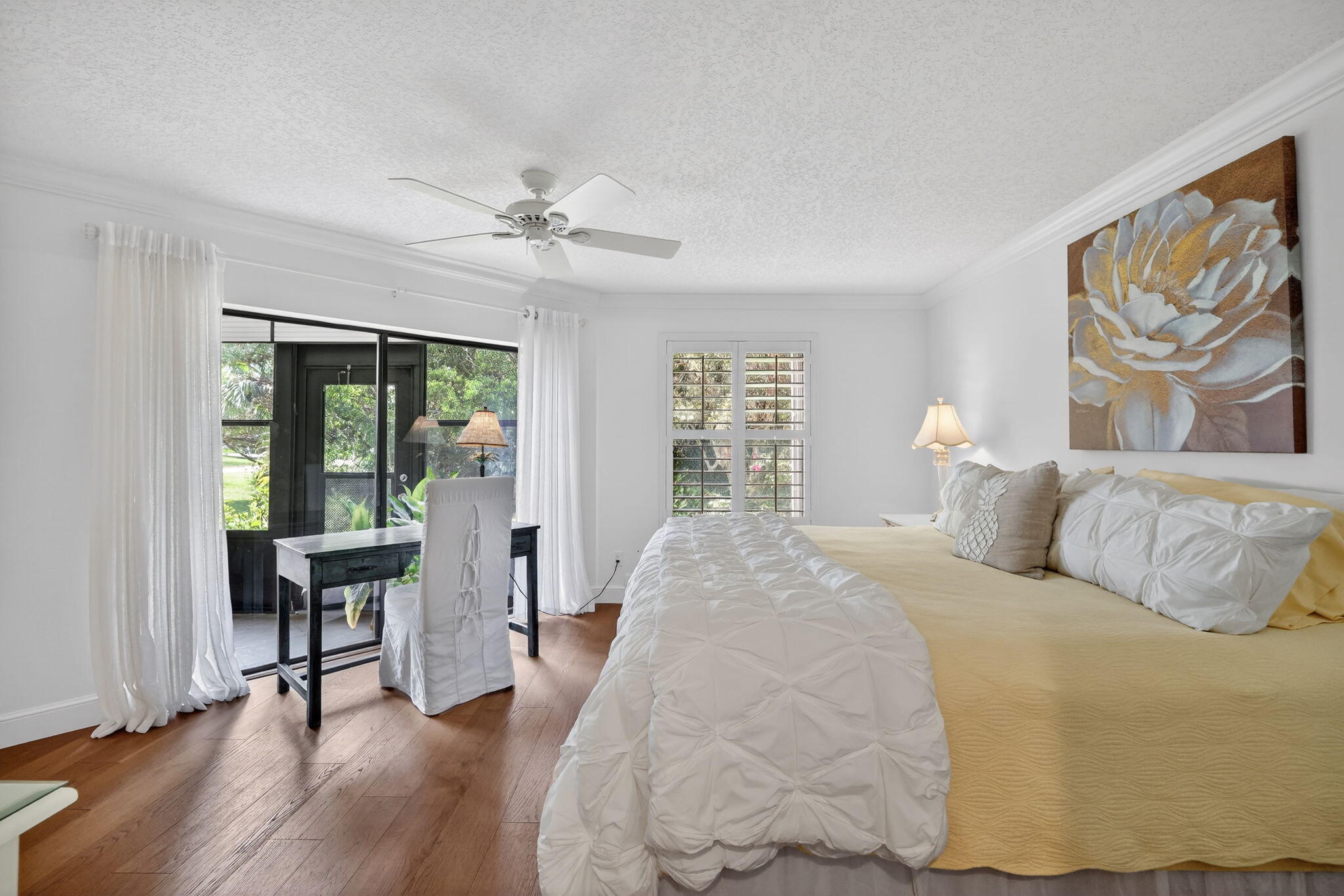 3401 Southeast Martinique Trace, Unit 102 Stuart, FL 34997 - Photo 22 of 56 a bed room with a bed and a painting on the wall