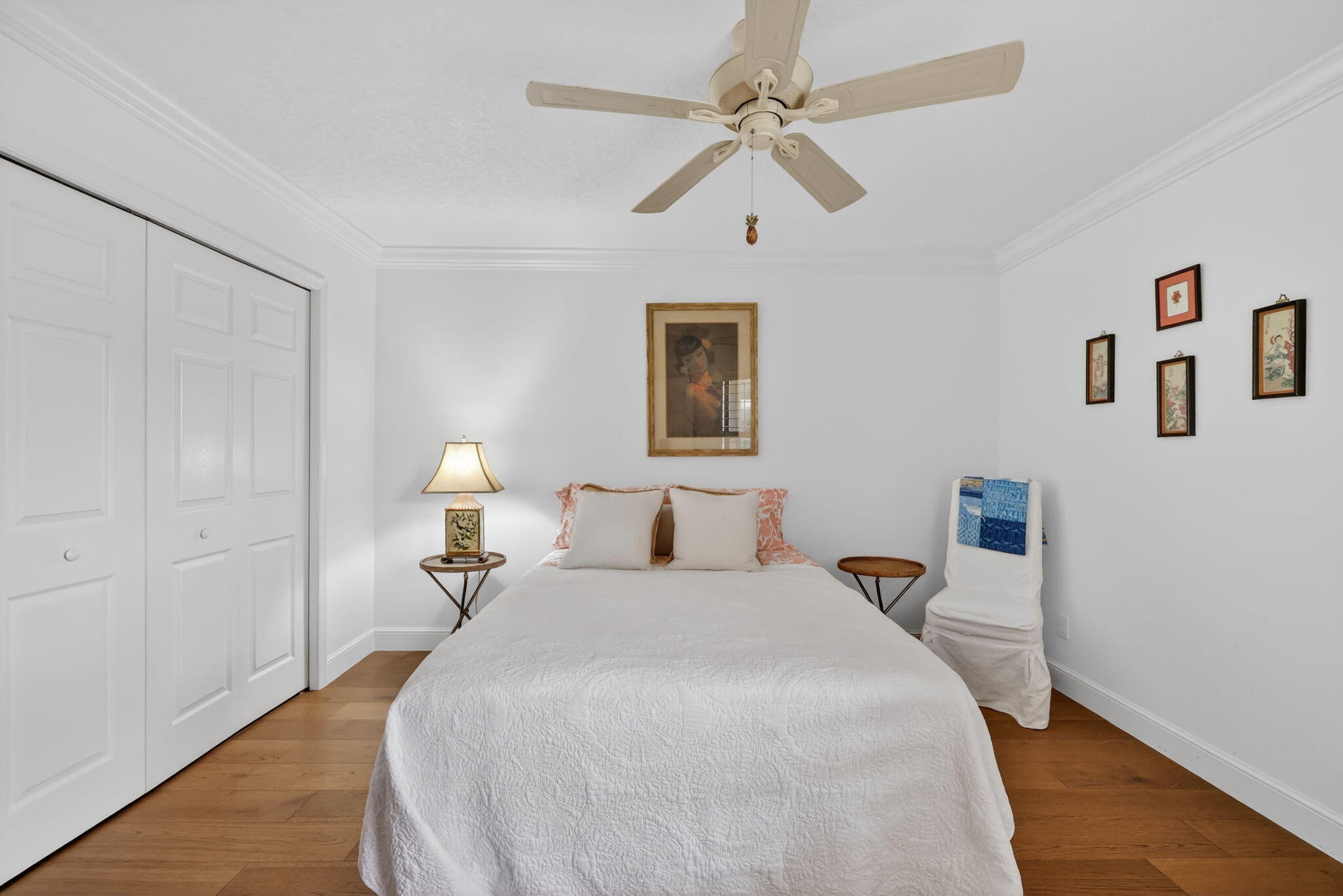 3401 Southeast Martinique Trace, Unit 102 Stuart, FL 34997 - Photo 28 of 56 a bedroom with a bed and a chandelier