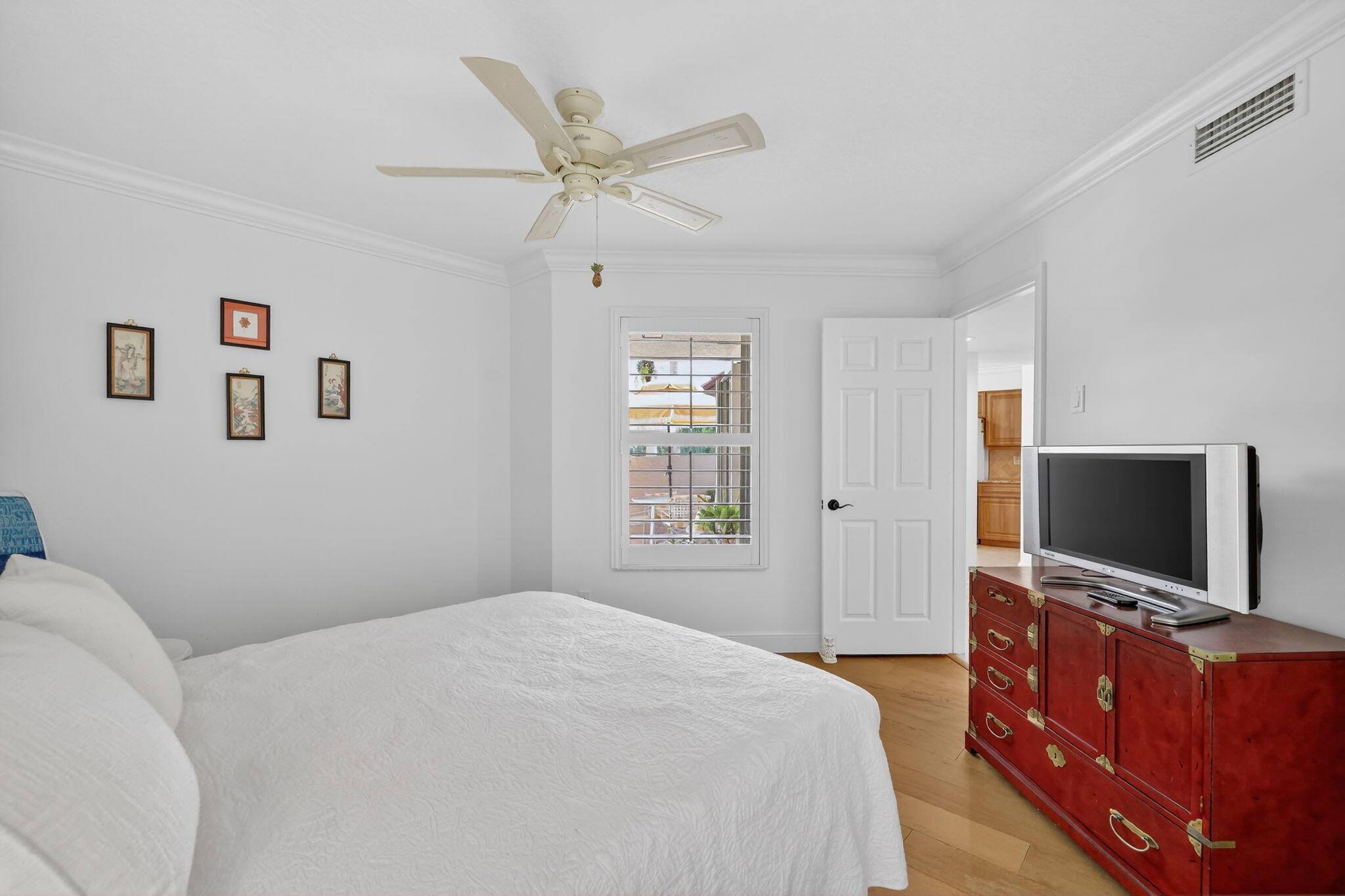 3401 Southeast Martinique Trace, Unit 102 Stuart, FL 34997 - Photo 29 of 56 a bedroom with a bed and a flat screen tv