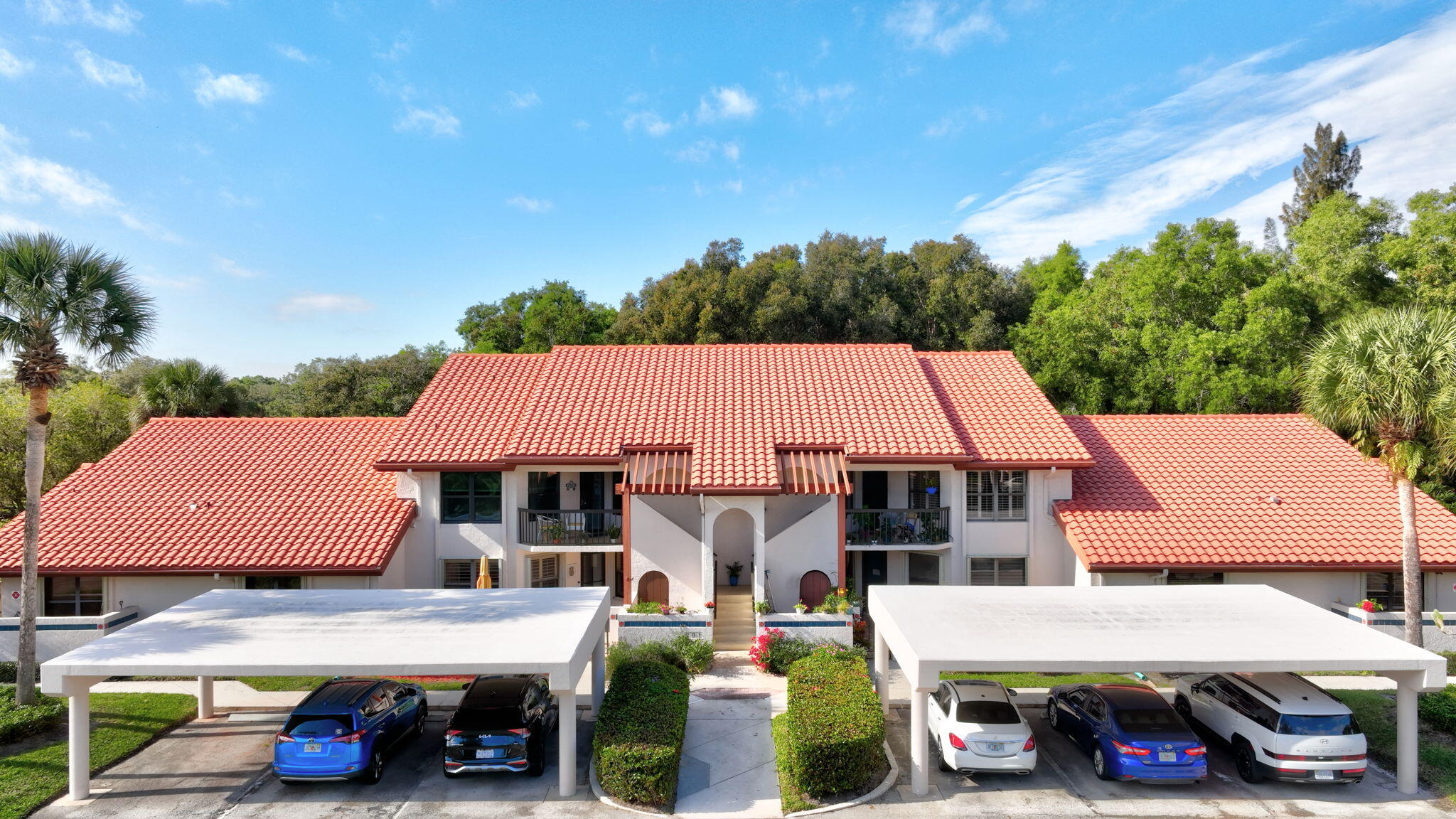 3401 Southeast Martinique Trace, Unit 102 Stuart, FL 34997 - Photo 38 of 56 a aerial view of a house with car parked