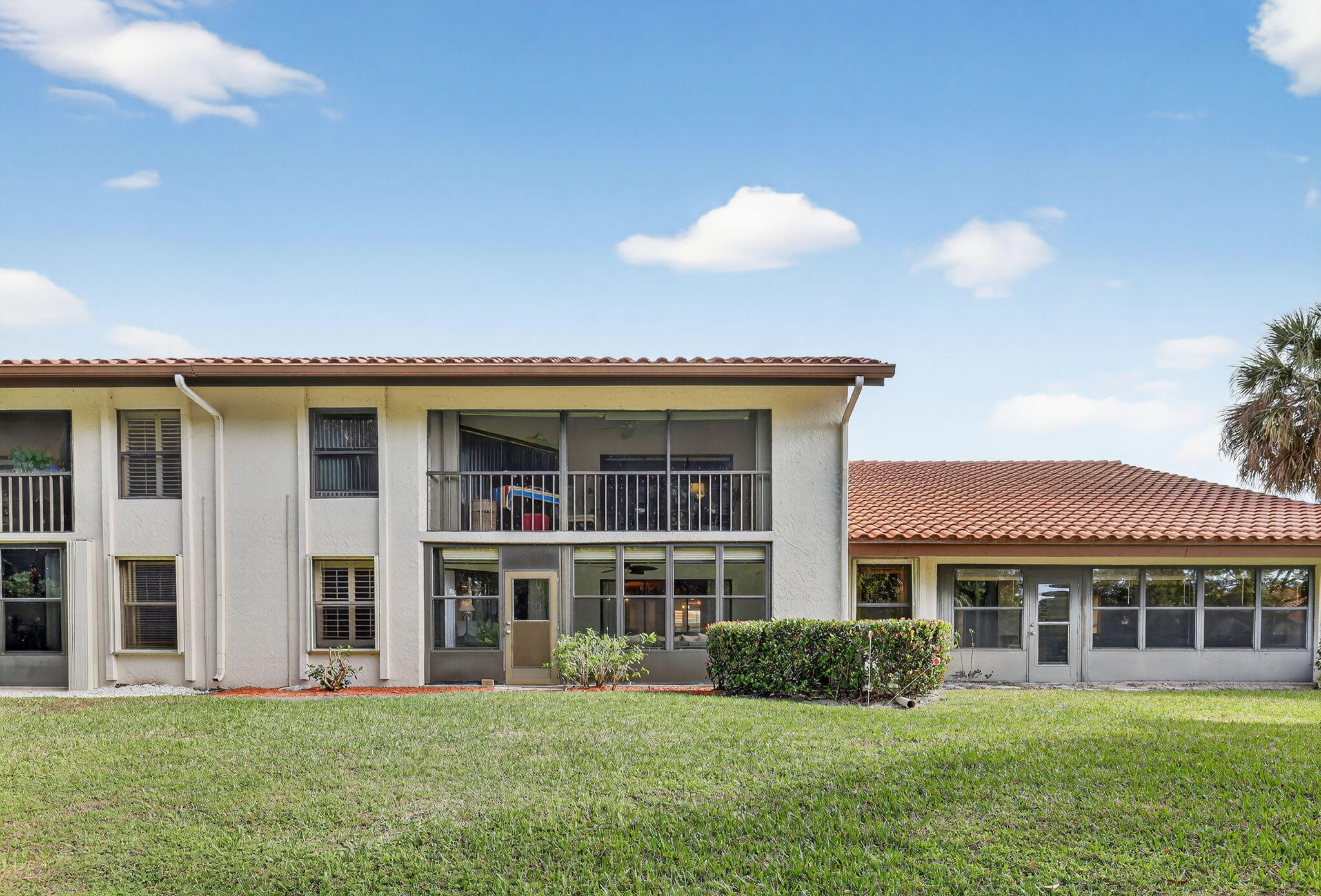 3401 Southeast Martinique Trace, Unit 102 Stuart, FL 34997 - Photo 40 of 56 a front view of a house with a yard