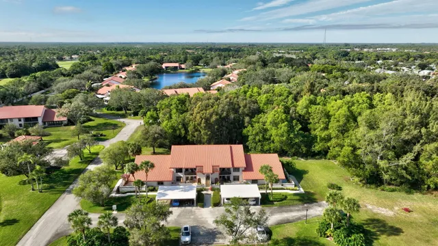 an aerial view of a house with yard swimming pool and outdoor seating