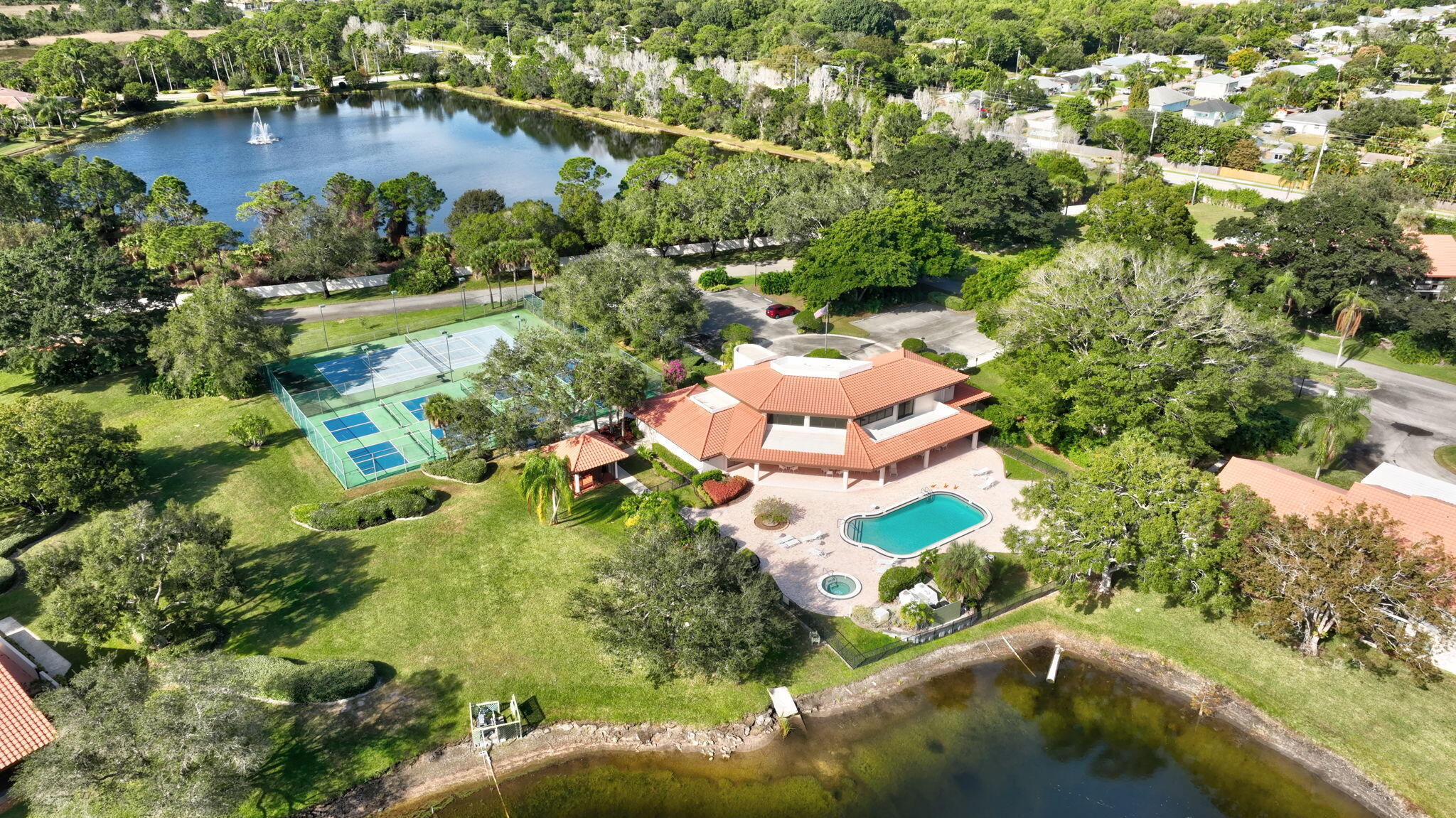 3401 Southeast Martinique Trace, Unit 102 Stuart, FL 34997 - Photo 54 of 56 an aerial view of residential houses with outdoor space and trees