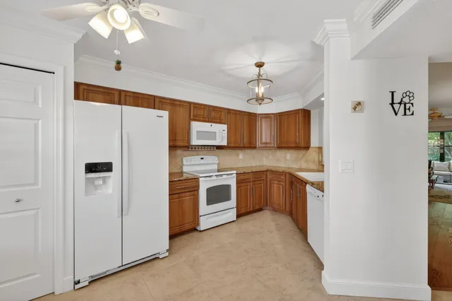 a kitchen with stainless steel appliances granite countertop a sink a stove a microwave and cabinets
