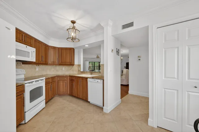 a kitchen with stainless steel appliances granite countertop a sink a stove and a microwave