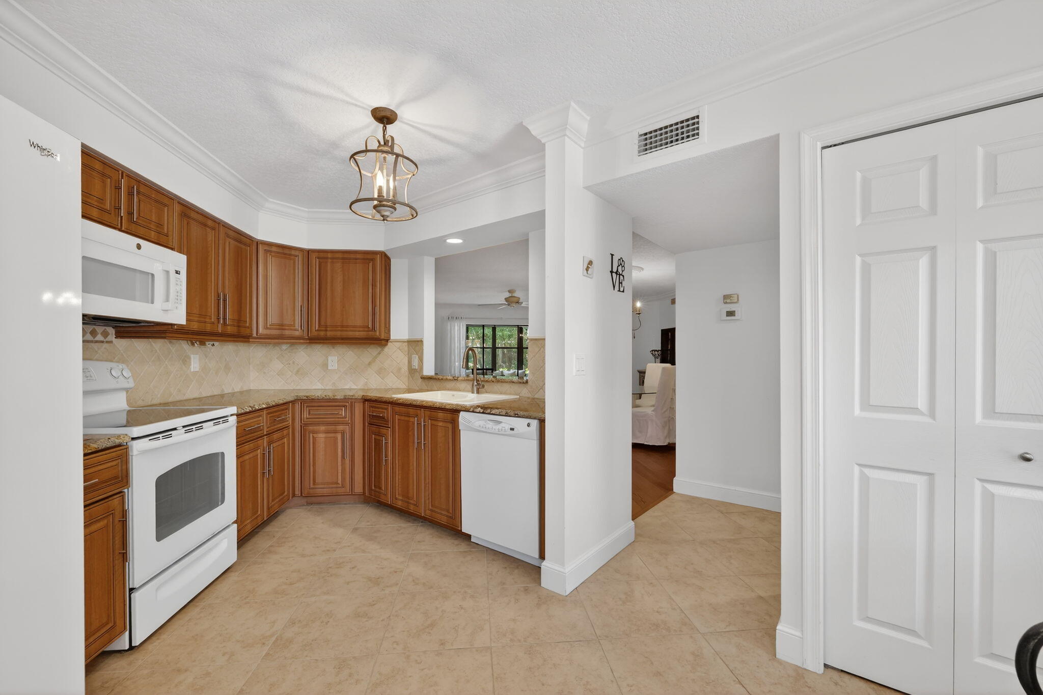 3401 Southeast Martinique Trace, Unit 102 Stuart, FL 34997 - Photo 10 of 56 a kitchen with stainless steel appliances granite countertop a stove oven and refrigerator