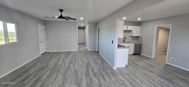 a view of a kitchen with wooden floor and a sink