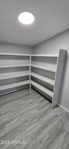 a view of a room with wooden floor and a chair