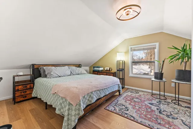 a spacious bedroom with a bed and a table in it