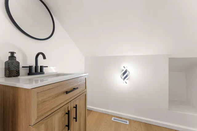 a bathroom with a sink and a mirror