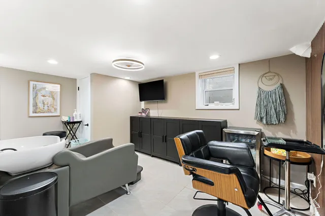 a livingroom with workspace couch and a window