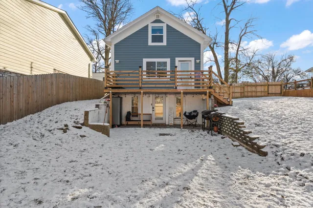 a front view of a house with a yard covered in snow