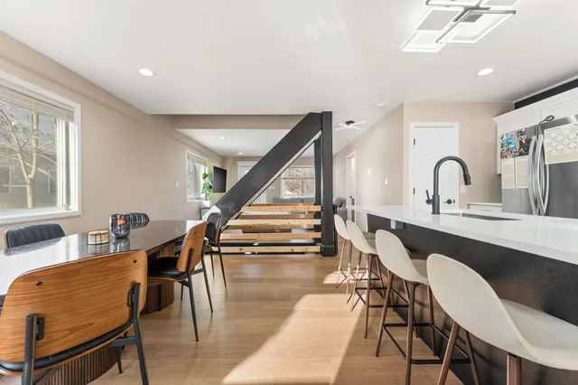 a dining room with furniture entryway and wooden floor
