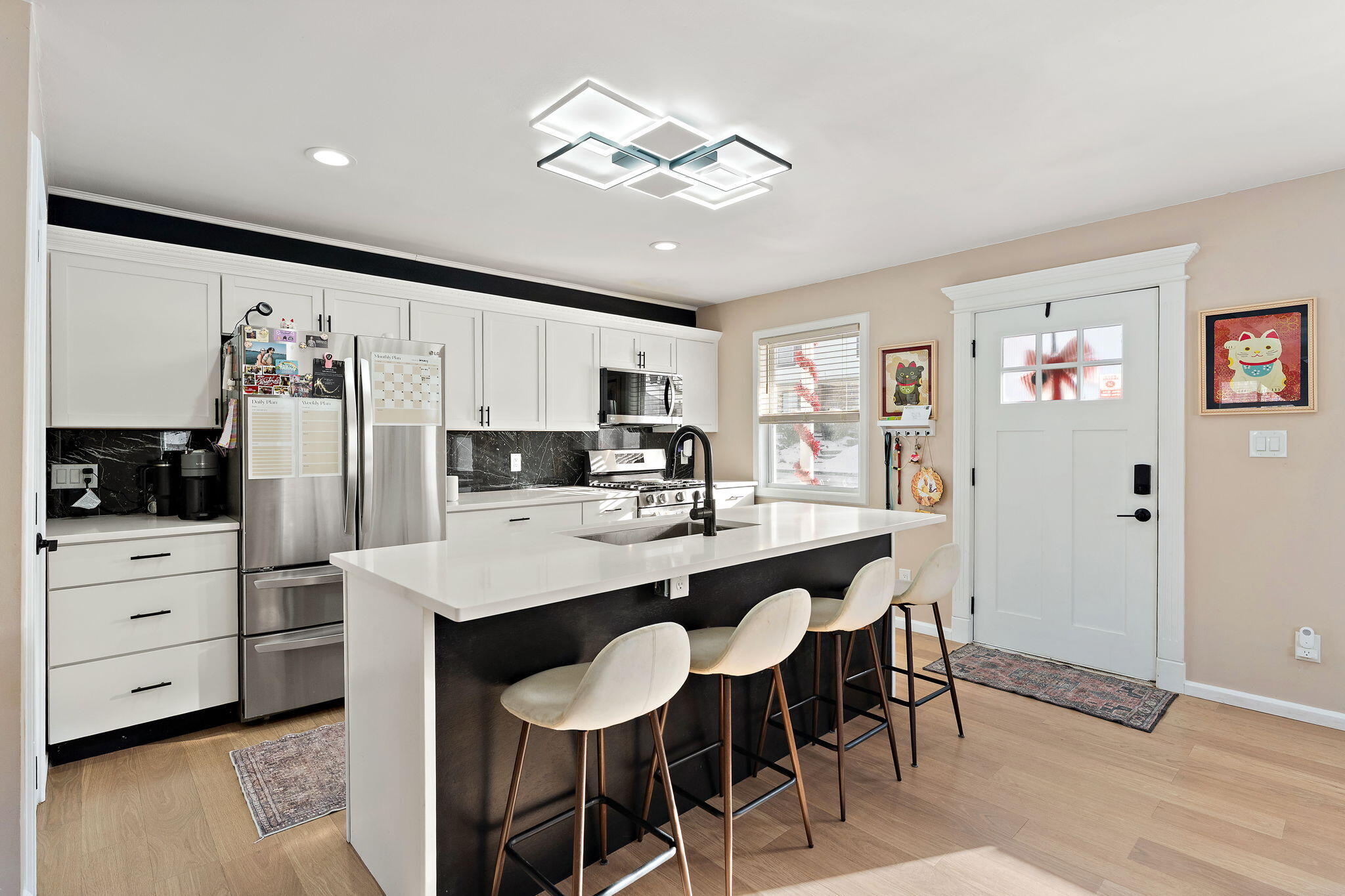 303 Union Street Valparaiso, IN 46383 - Photo 6 of 30 a kitchen with white cabinets and stainless steel appliances
