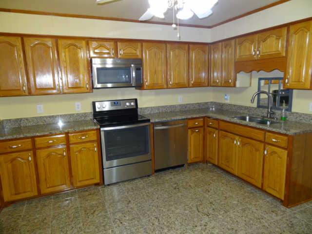 702 3rd Avenue West Springfield, TN 37172 - Photo 8 of 16 a kitchen with granite countertop stainless steel appliances a stove sink and microwave