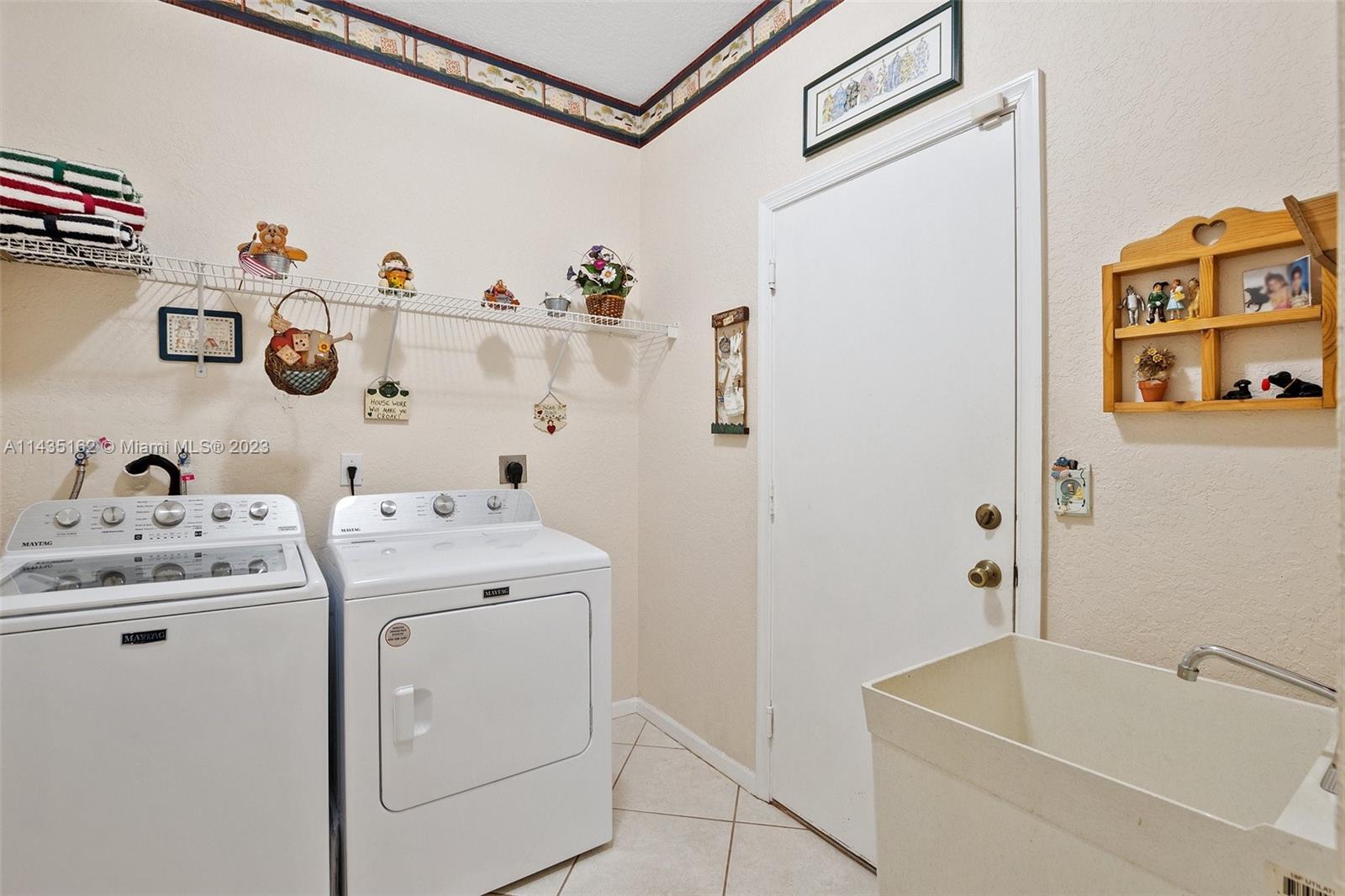 3165 Southwest 176th Way Miramar, FL 33029 - Photo 12 of 32 a view of washer and dryer with laundry on a shelf