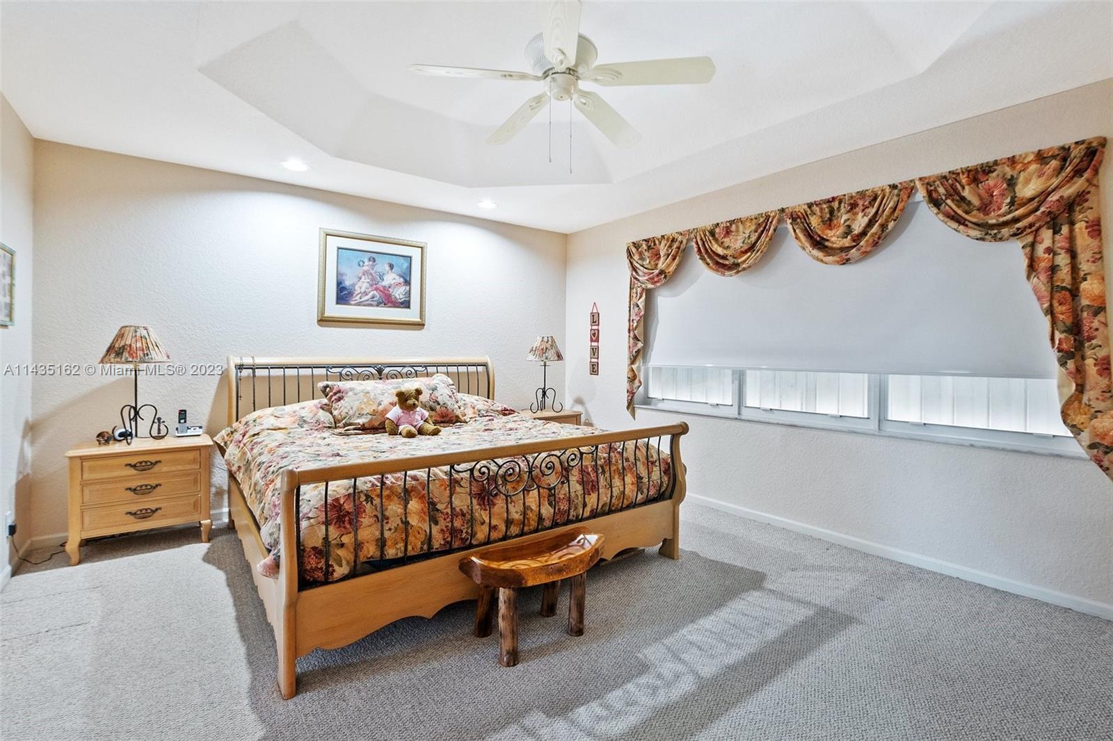 3165 Southwest 176th Way Miramar, FL 33029 - Photo 14 of 32 a bedroom with a bed and a chandelier