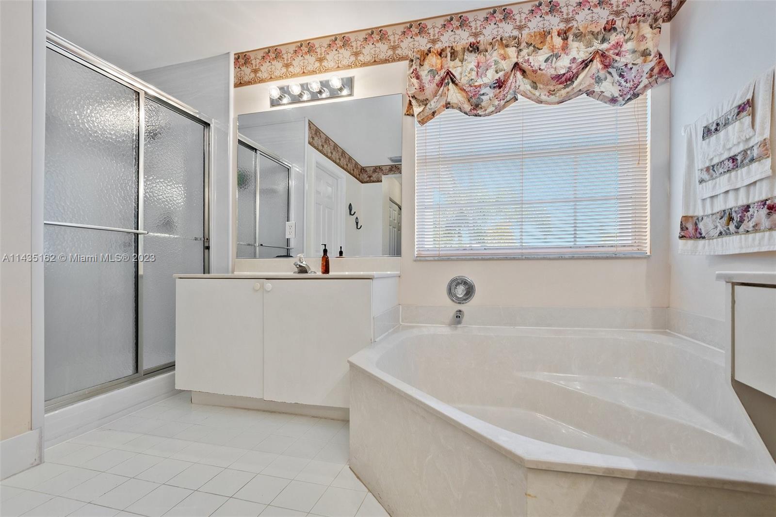 3165 Southwest 176th Way Miramar, FL 33029 - Photo 17 of 32 a bathroom with a bathtub and a shower
