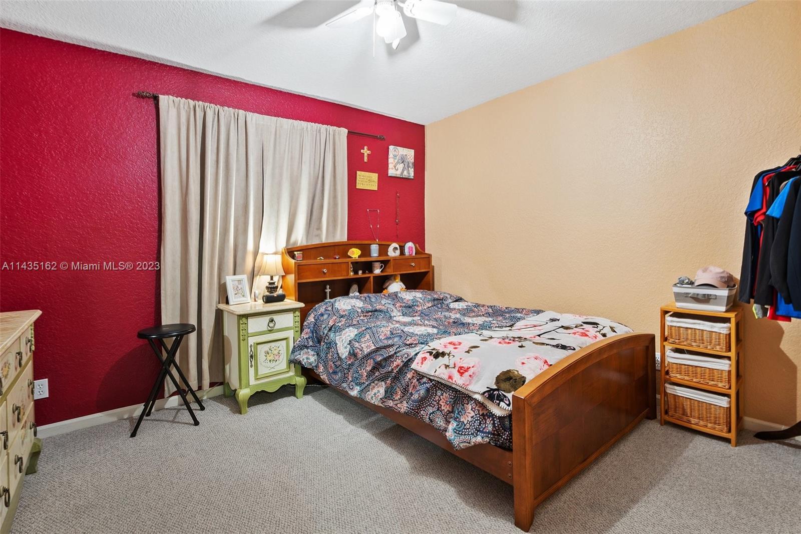 3165 Southwest 176th Way Miramar, FL 33029 - Photo 18 of 32 a bed sitting in a bedroom next to a window