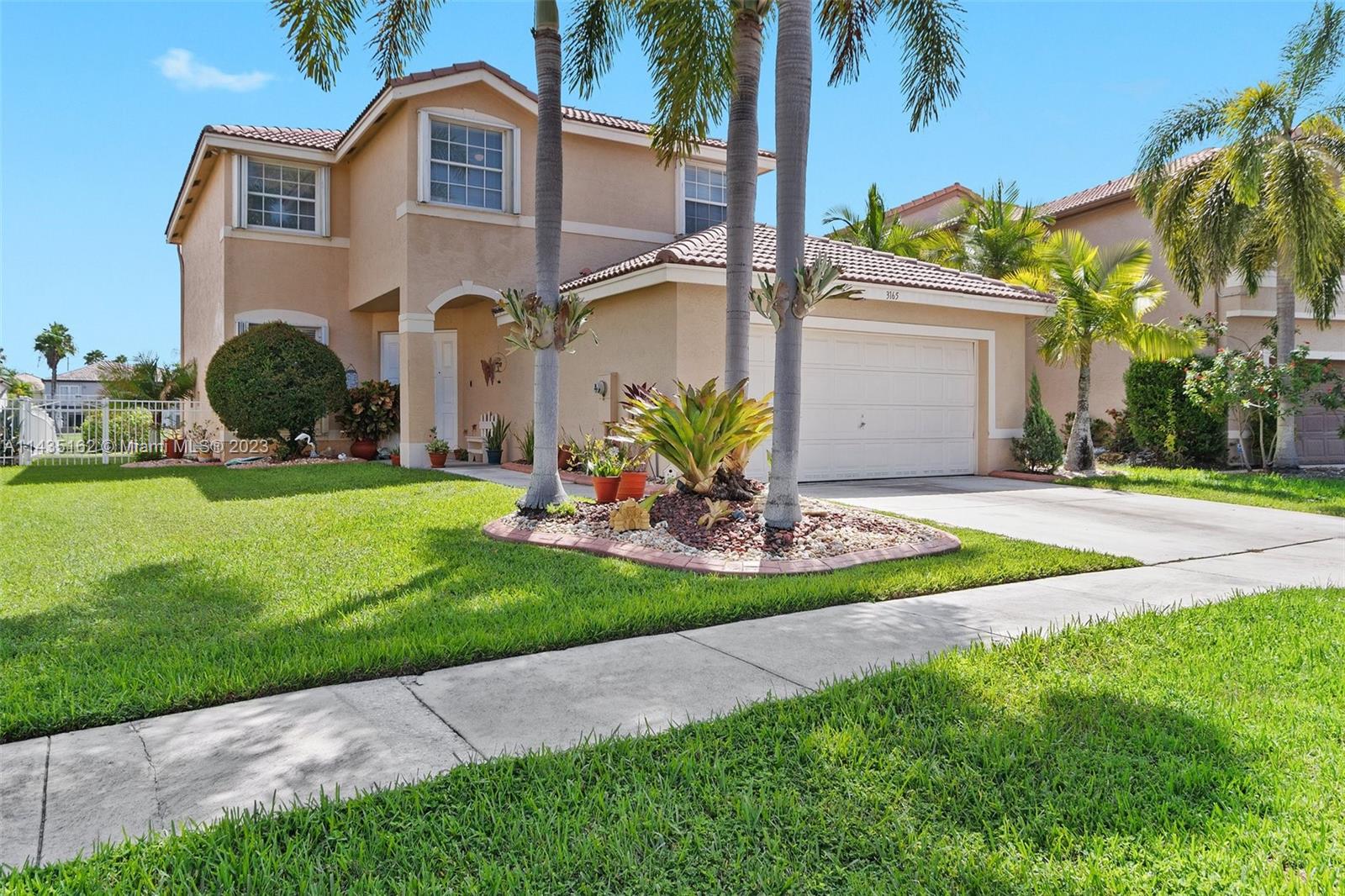 3165 Southwest 176th Way Miramar, FL 33029 - Photo 2 of 32 a front view of a house with a yard