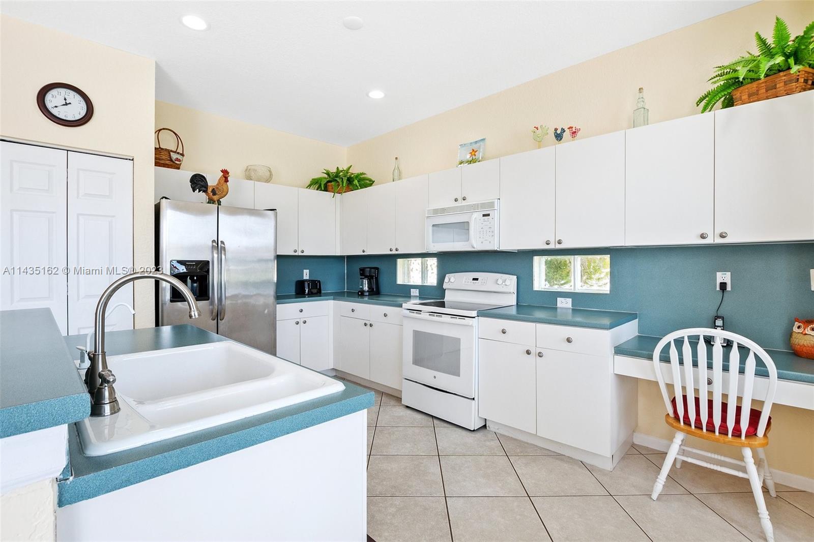 3165 Southwest 176th Way Miramar, FL 33029 - Photo 7 of 32 a kitchen with a sink cabinets and appliances