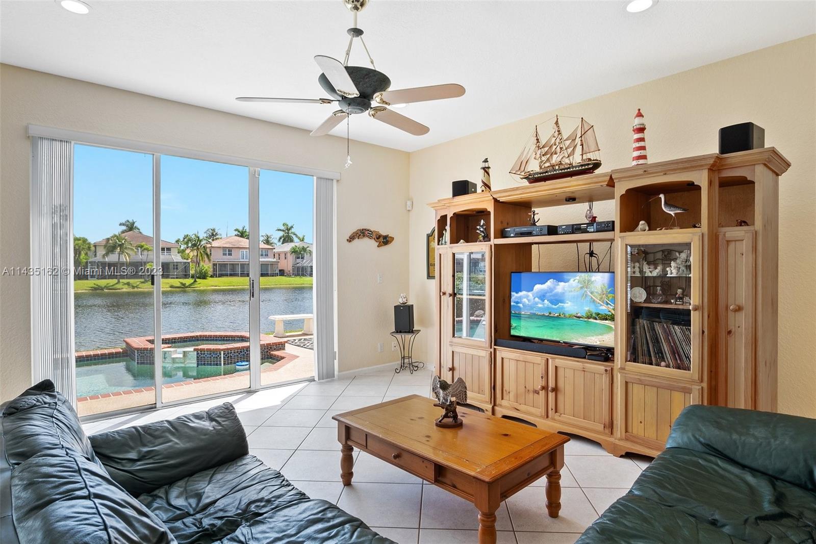 3165 Southwest 176th Way Miramar, FL 33029 - Photo 10 of 32 a living room with furniture and a flat screen tv