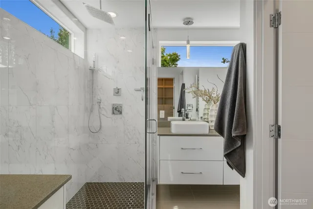 a bathroom with a shower and a sink
