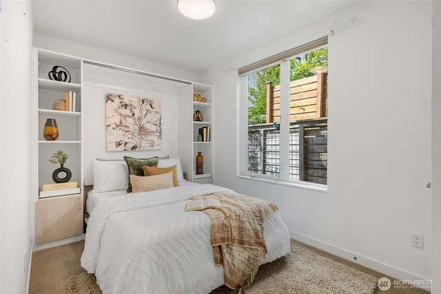 a bedroom with a bed and a window