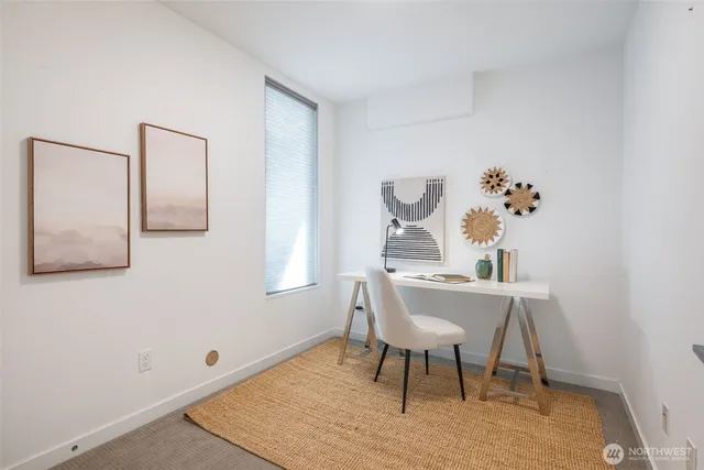 a view of a workspace with furniture and window