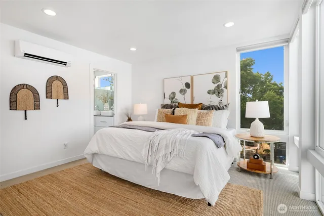 a bedroom with a bed couch and a window